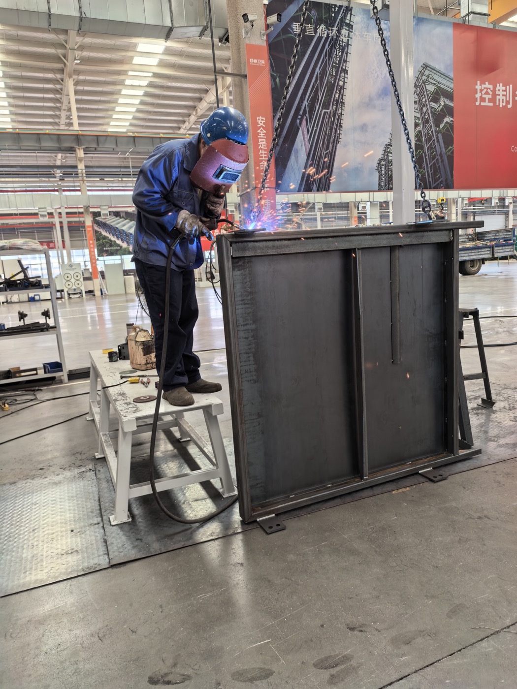 BECHUR technician welding a transfer-cart frame